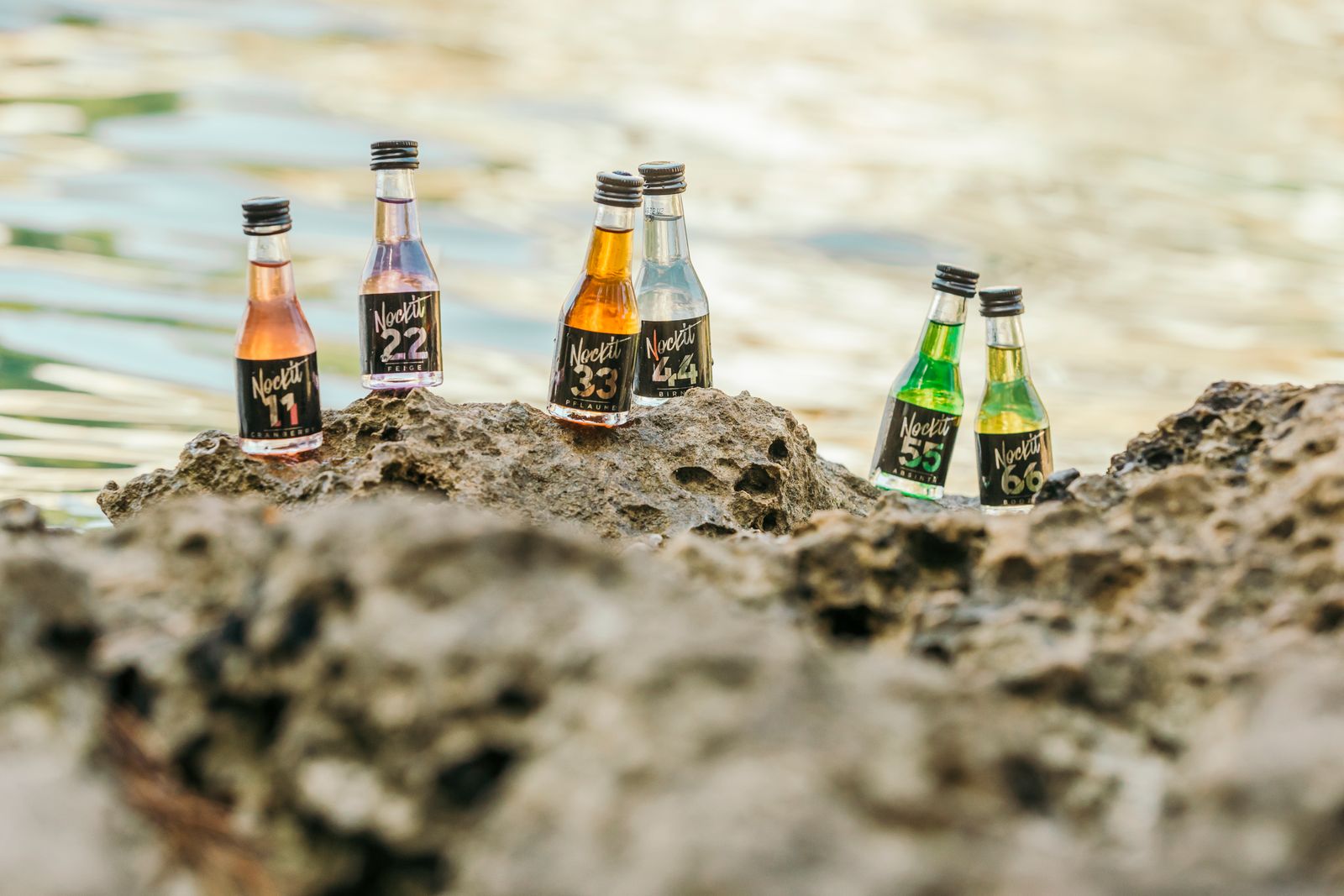 Nockit-Fläschchen auf Felsen am Meer