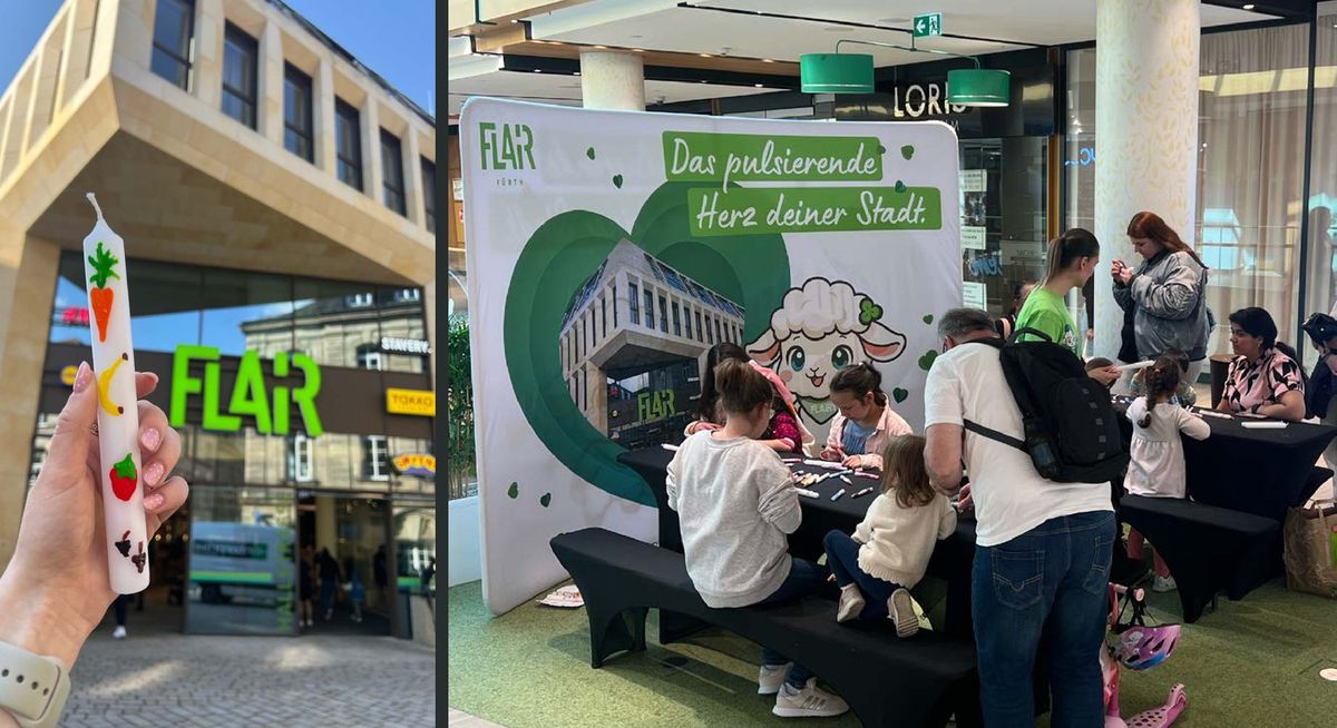 Mit Wachsfarben verzierte Stabkerze vor dem FLAiR-Eingang und Besucher am Aktionstisch vor der FLAiRY-Rückwand