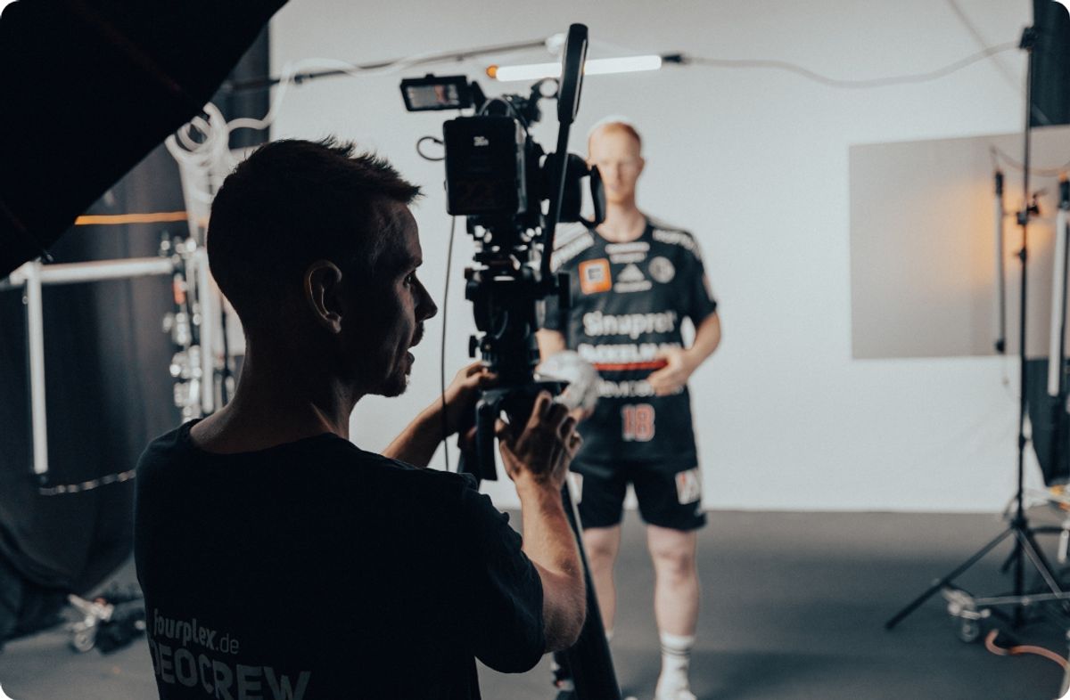 Kameramann der fourplex-Videocrew filmt im Studio einen Spieler des HC Erlangen im schwarzen Trikot mit der Nummer 18